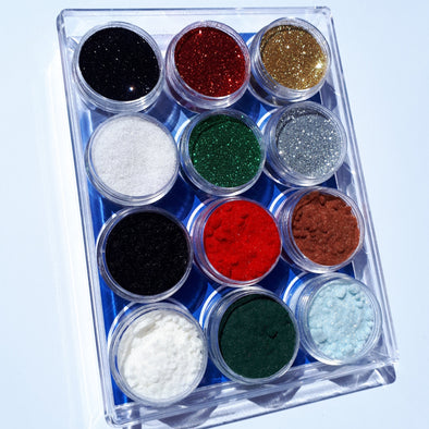 A boxed set of glitters and flock in Traditional Christmas colours, all sparking in the sun.