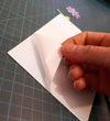 Peeling away the liner from double sided adhesive Sticky Roll