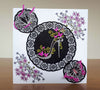 Handmade card with die cut butterfly, shoe and round decorative die cut shapes, decorated with flock and glitter, with coloured in stamps