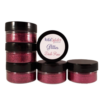 Jars of Dark Rose pink glitter stacked on top of one another