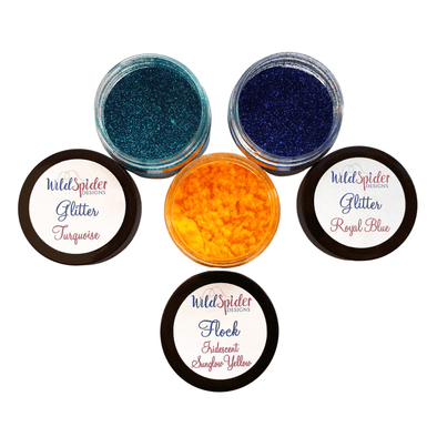 Three open pots, two of glitter and one of flock for crafting. The colours are; Turquoise glitter, Royal Blue glitter, and Sunglow Yellow flock.