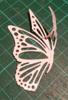 A die cut butterfly covered in Sticky Roll on a cutting mat with part of the liner peeled away